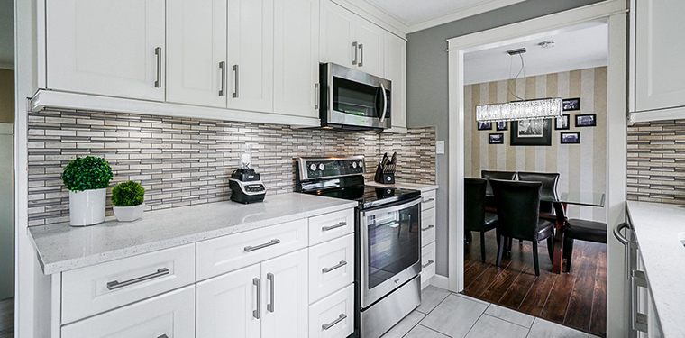Bright open-concept kitchen remodel in North Vancouver featuring shaker cabinets and pendant lighting